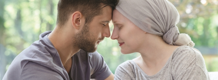 man and woman with foreheads together 